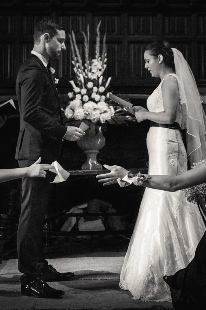 Black and white: a bride and groom reading their vows at the altar
