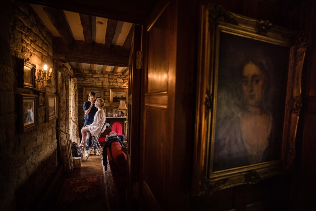 Intimate wedding portrait of bride during make-up