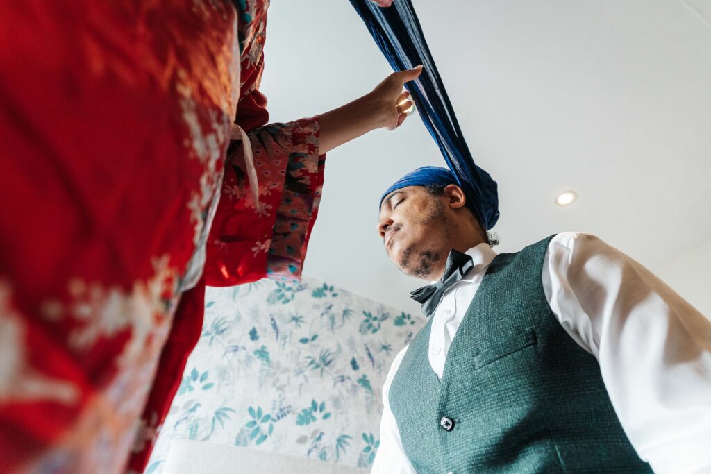 Indian fusion wedding in Kent - Sikh Bride tying her husband's turban