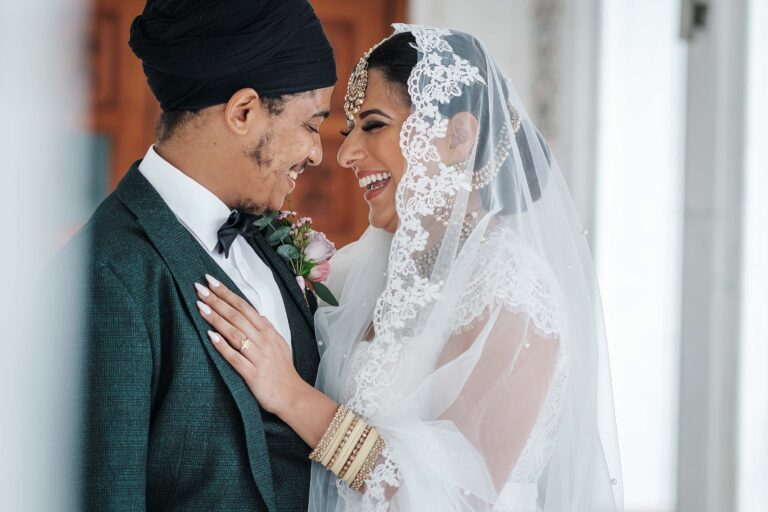 Indian Fusion Wedding kent showing bride & Groom laughing together at the Gravesend Gurdwara
